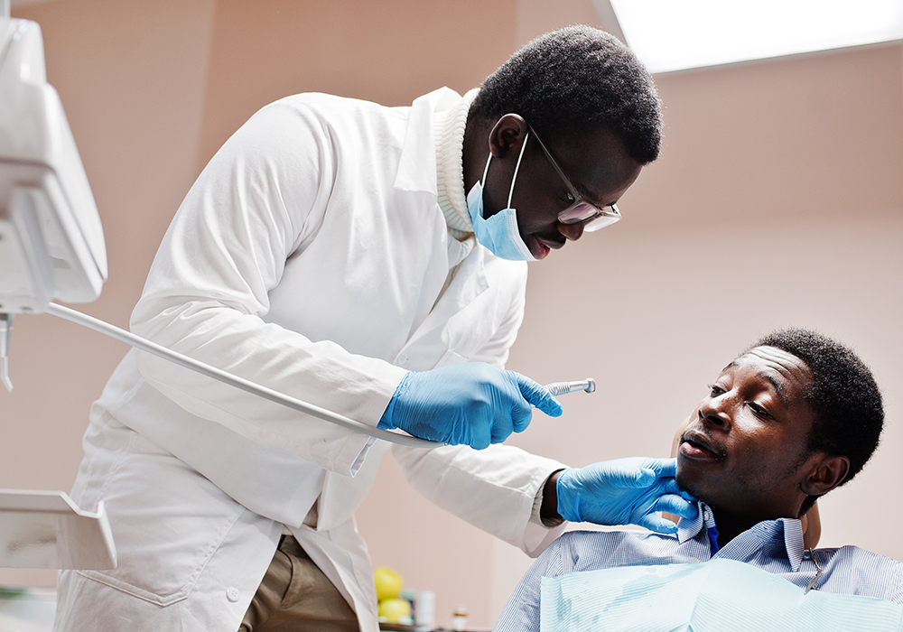 A male is looking at his dentsit with hesitation