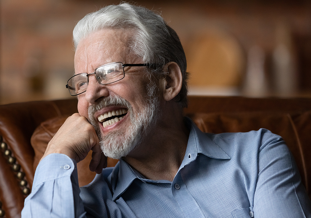 Old man smiling with new dental implants