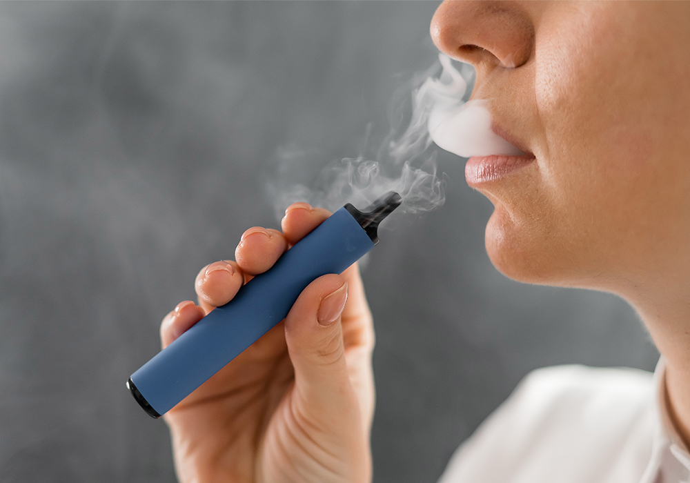 Close-up shot of a woman vaping