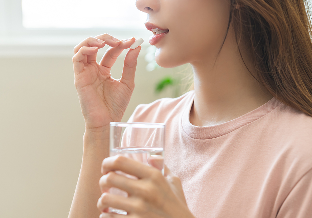 Close-up of a woman taking over-the-counter meds