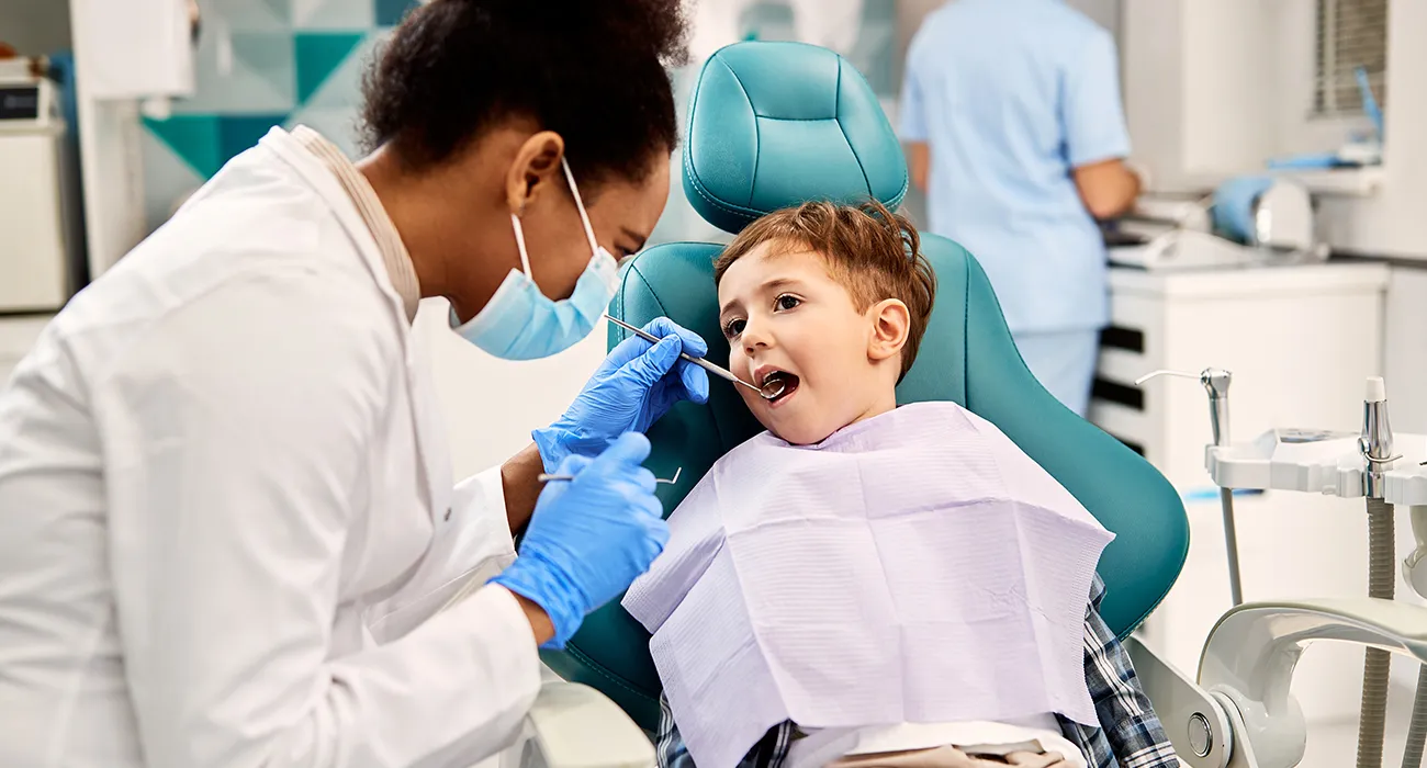Dentist inspecting a child’s teeth