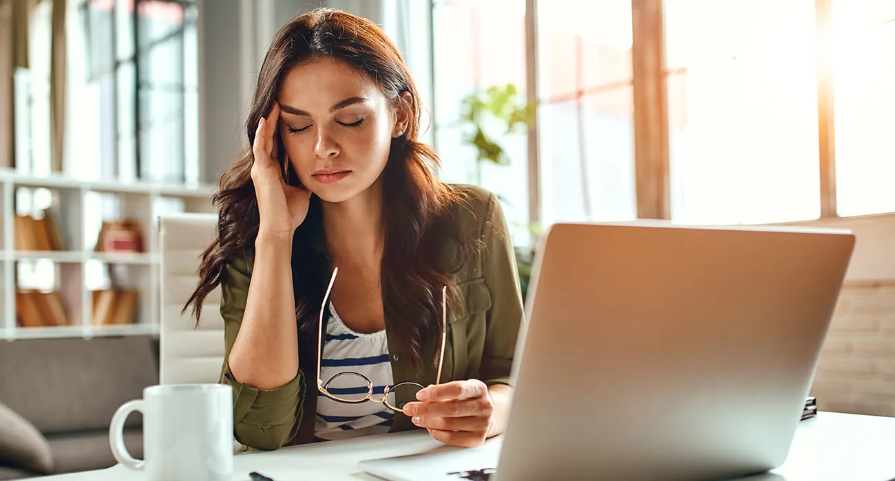 woman at computer looking stressed