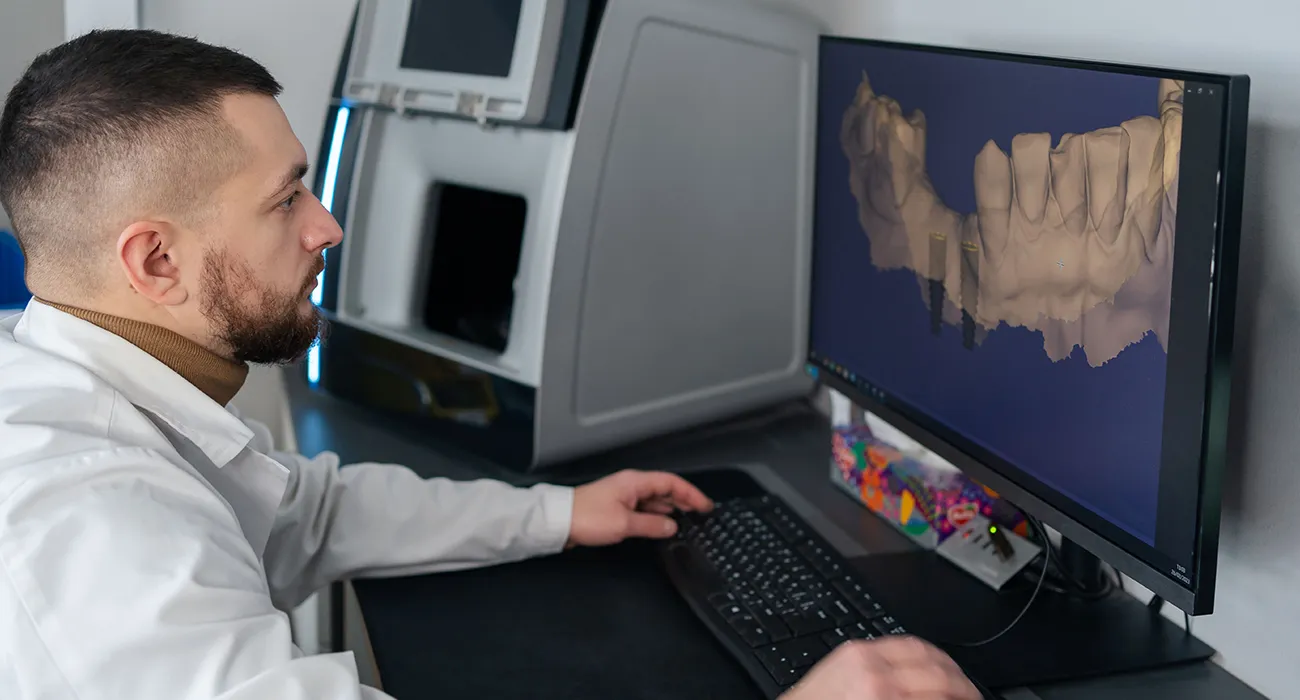 Dentist reviewing a dental X-ray on a computer