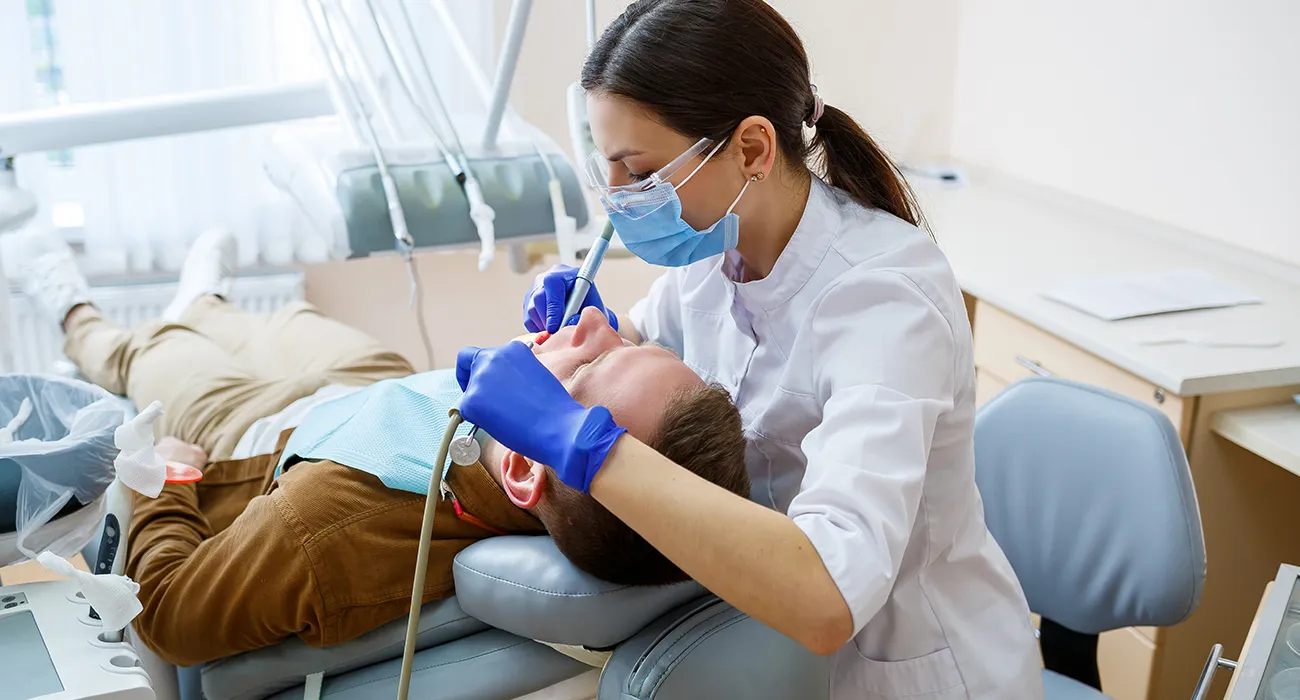 dentist inspecting man's mouth