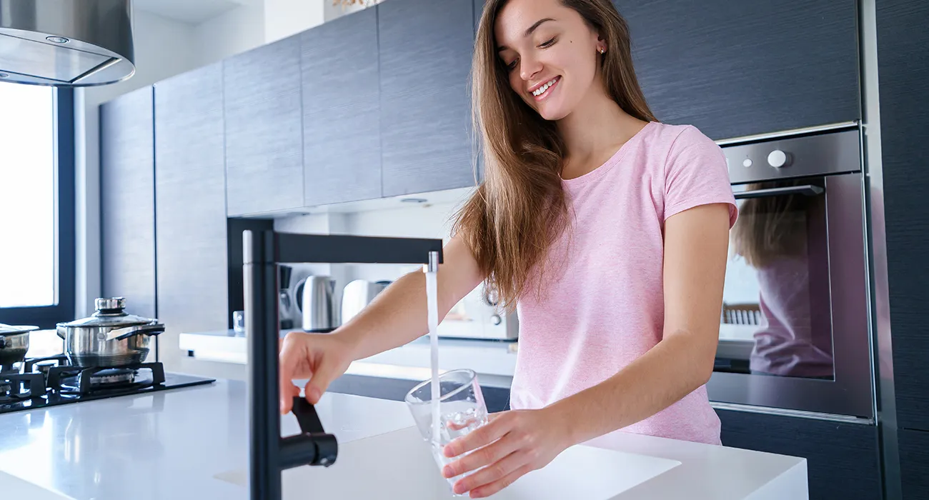 woman pouring glass of water